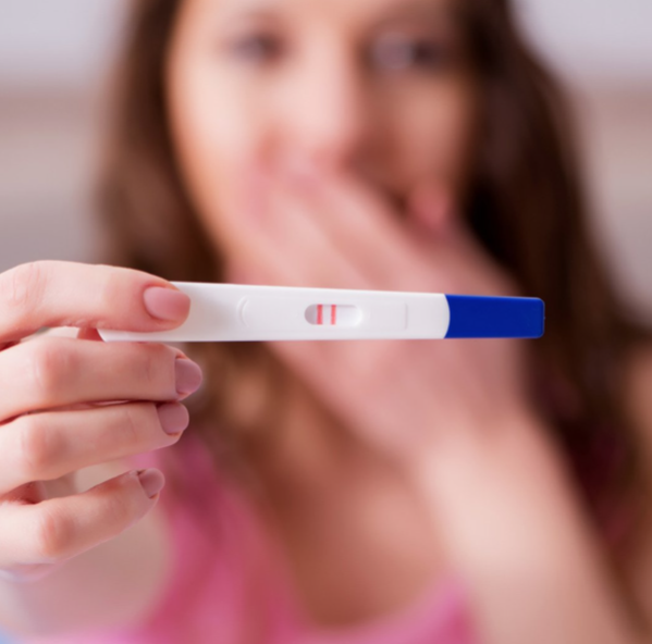 women holding pregnancy test