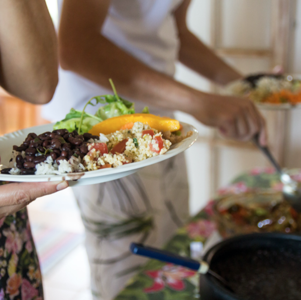 people serving vegan dishes
