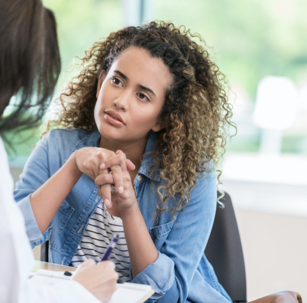 young woman talking with doctor