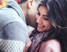Wife receiving kiss on the cheek from husband