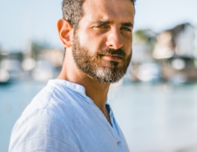 Healthy looking man standing by water