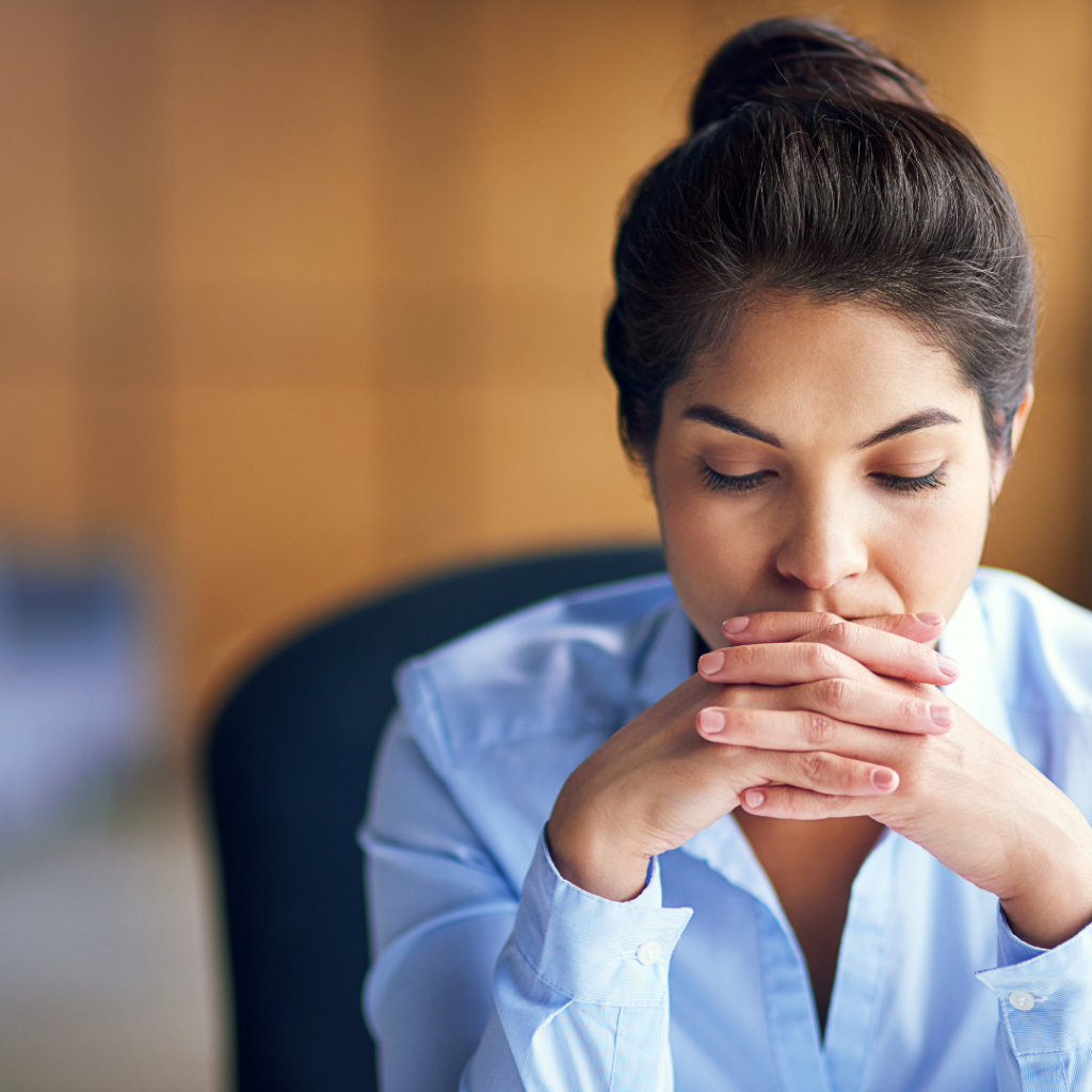 Woman at work feeling fatigued.