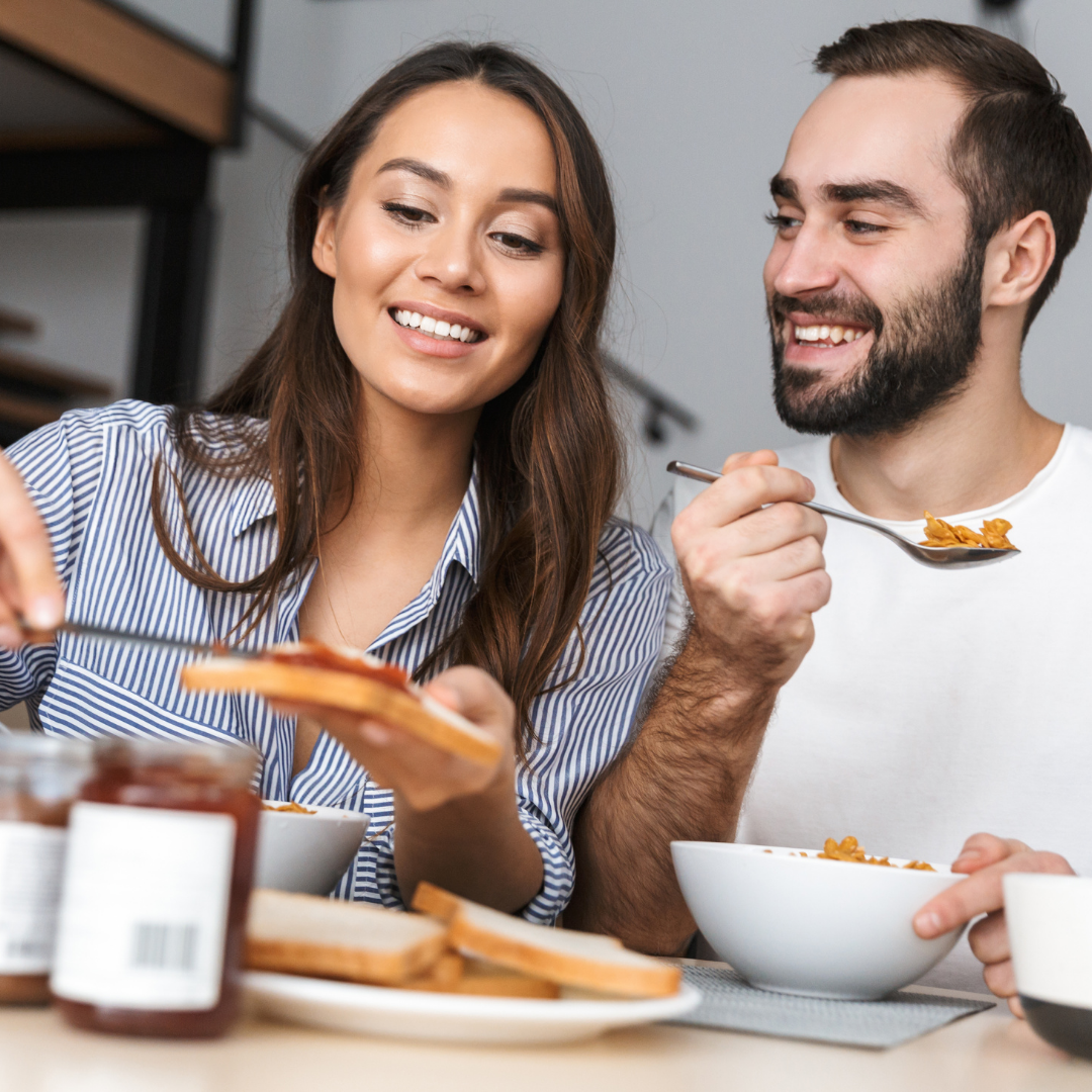 Couple sitting at the table eating breakfast