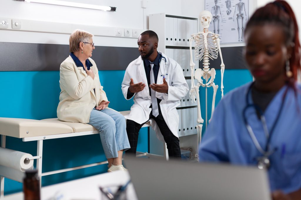 African American doctor doing physical exam with older patient 