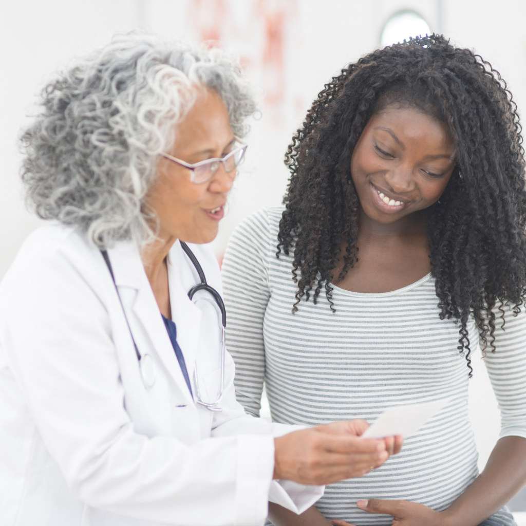 African American doctor talking with young patient.