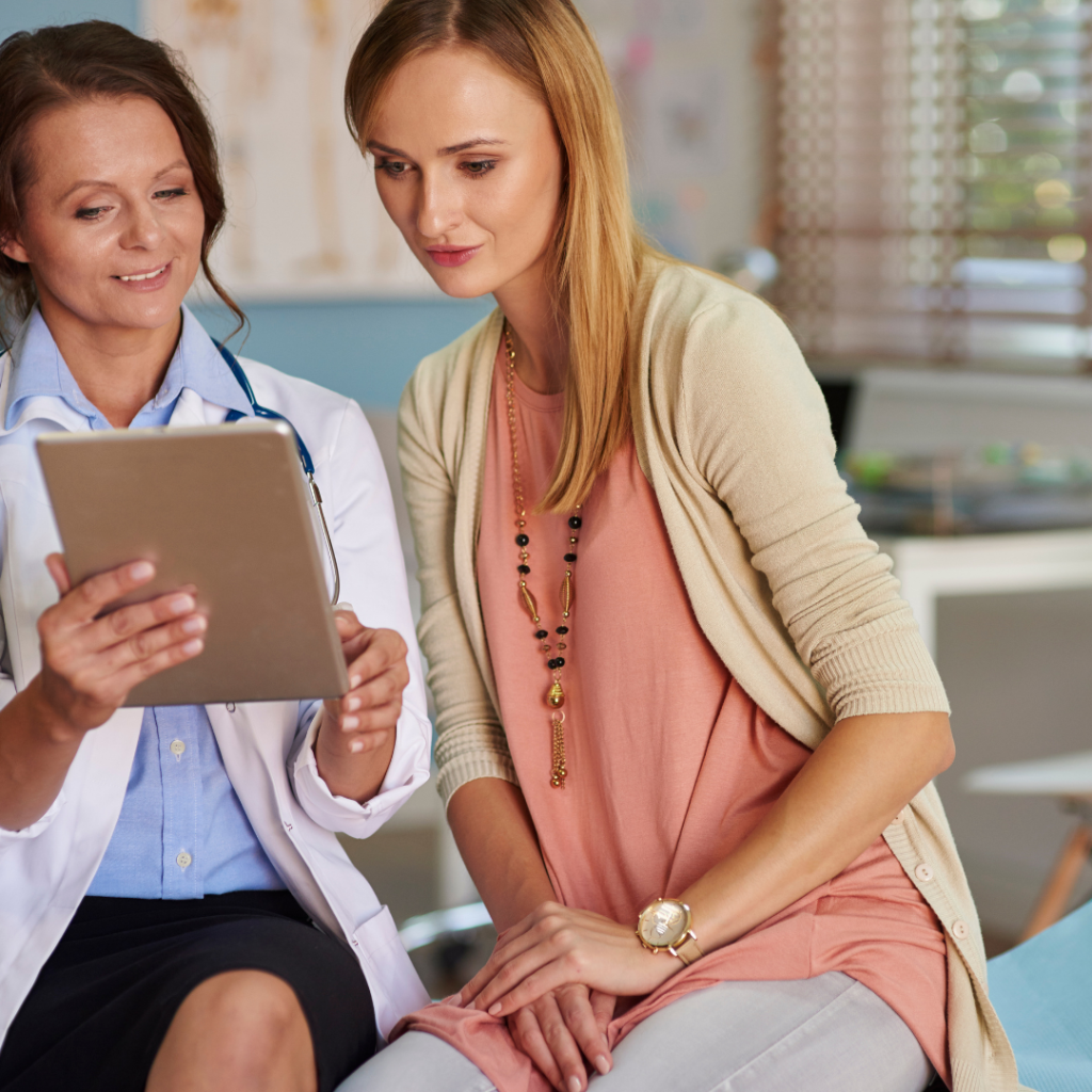 Woman doctor showing her patient her results on a tablet.
