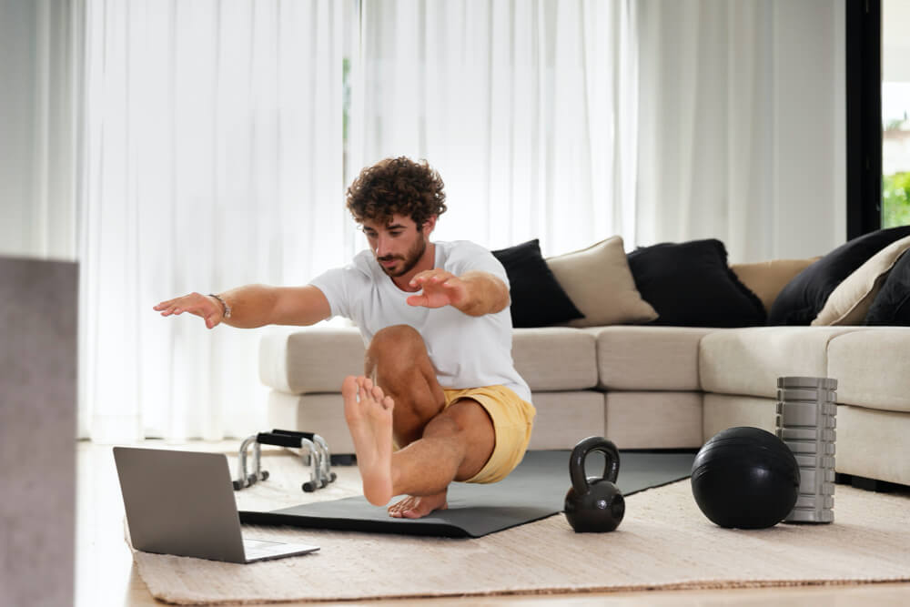 man working out at home with kettlebells