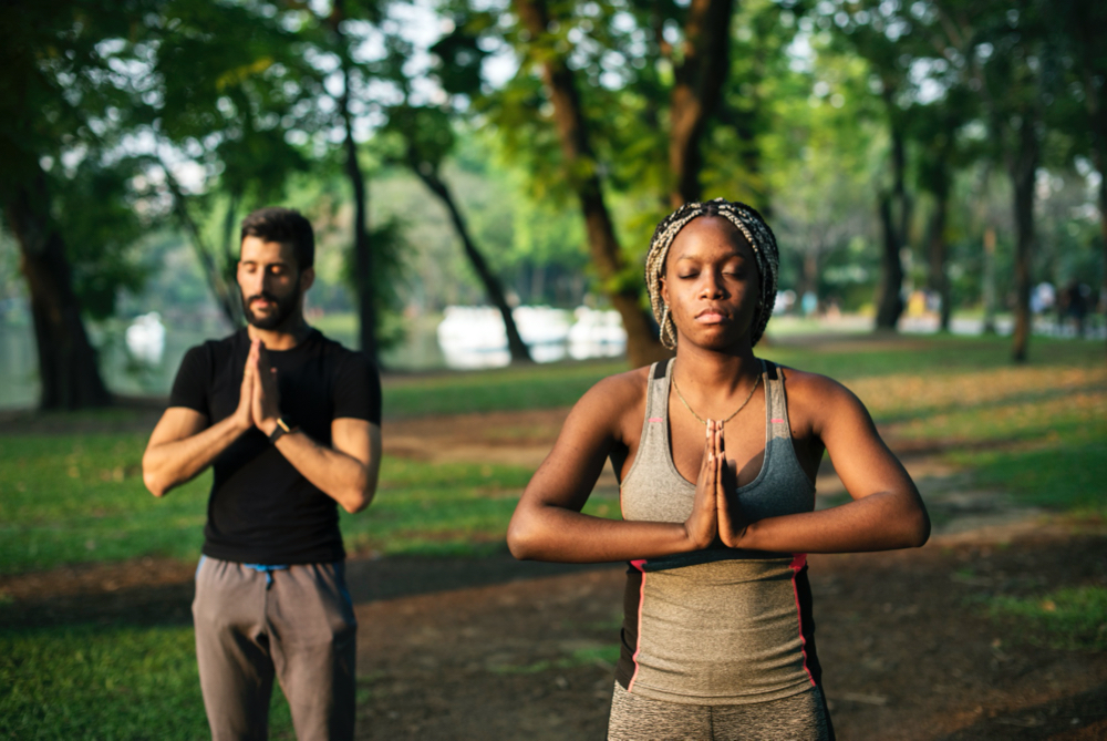 people yoga in a park