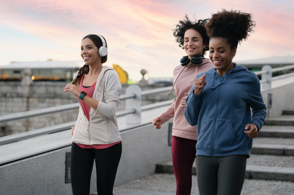three beautiful athletic women running together to be healthier