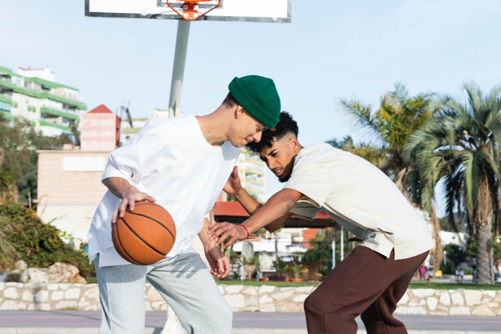 two men playing basketball to relieve stress and exercise