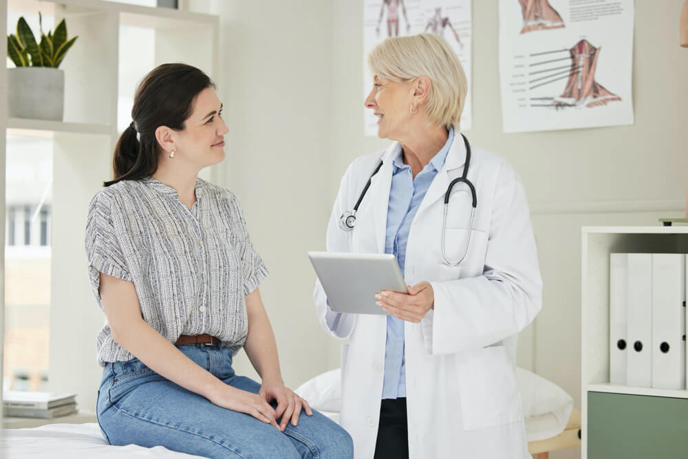 concerned woman talking to doctor at office about her abnormal BUN lab results