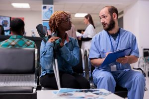 Patient speaking with medical staff in clinic waiting area for blood testing in Jacksonville