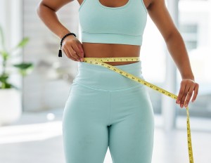 Fitness health and body of woman with tape measure for weight loss